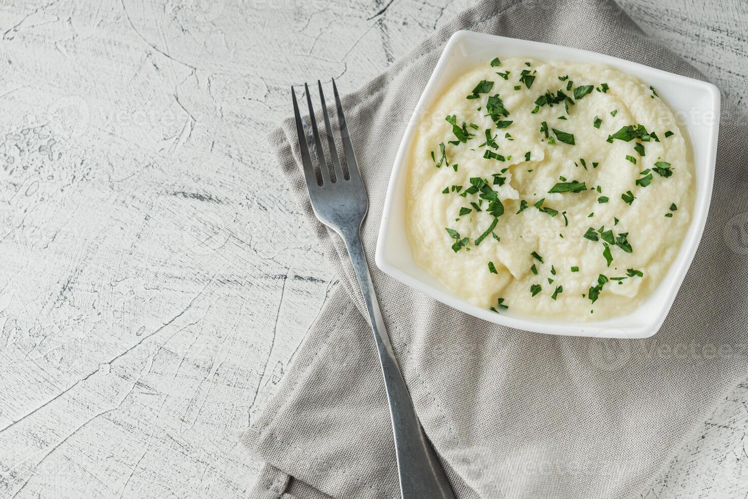 delicious mashed cauliflower on a white background photo