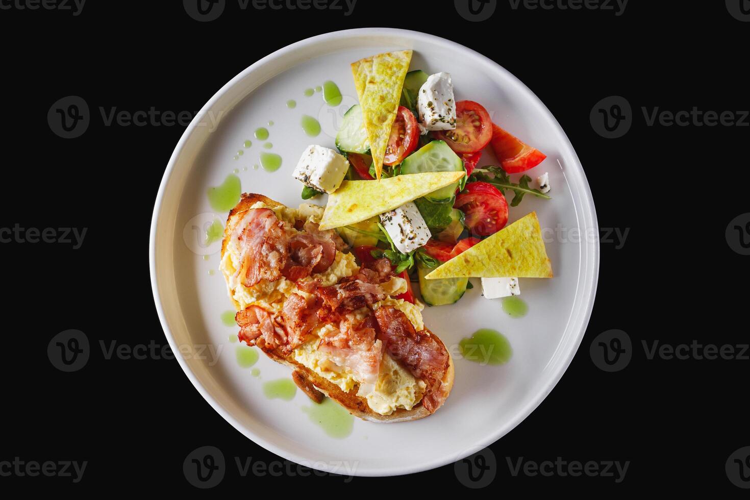 toast with scramble and bacon on a white plate photo