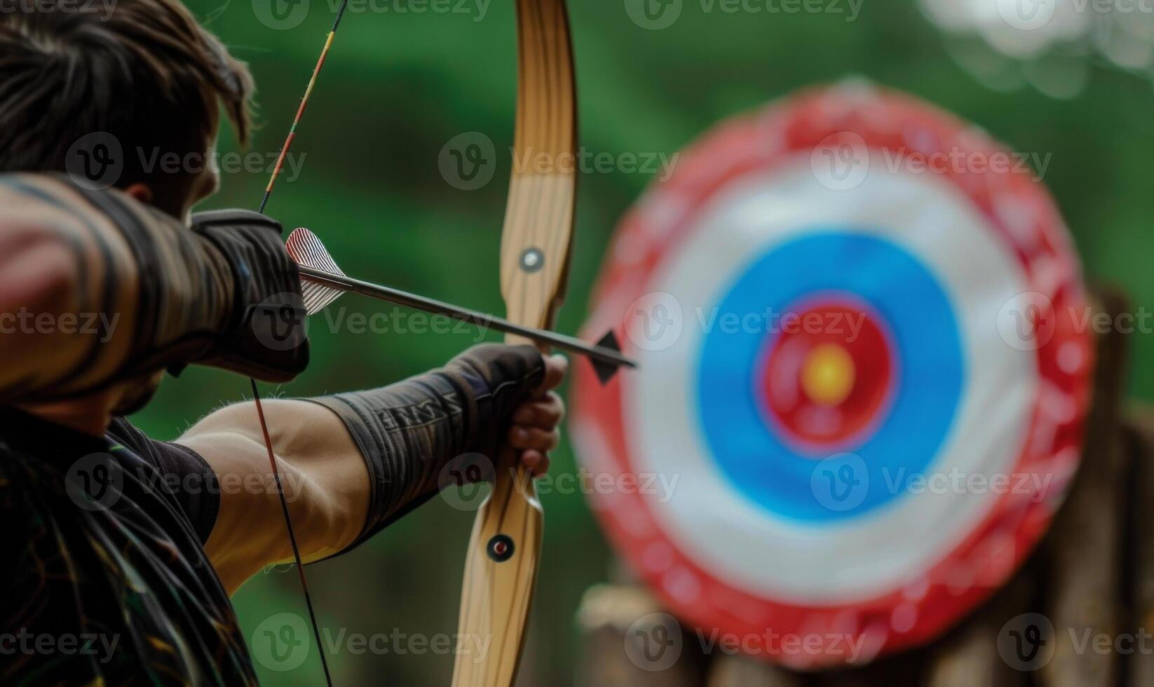 An archer's body aiming a bow, with the target in the background photo