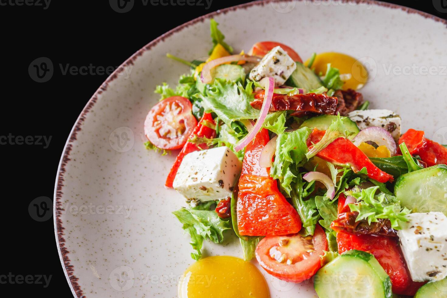 salad with baked bell peppers tomatoes cucumber red onion and feta cheese photo