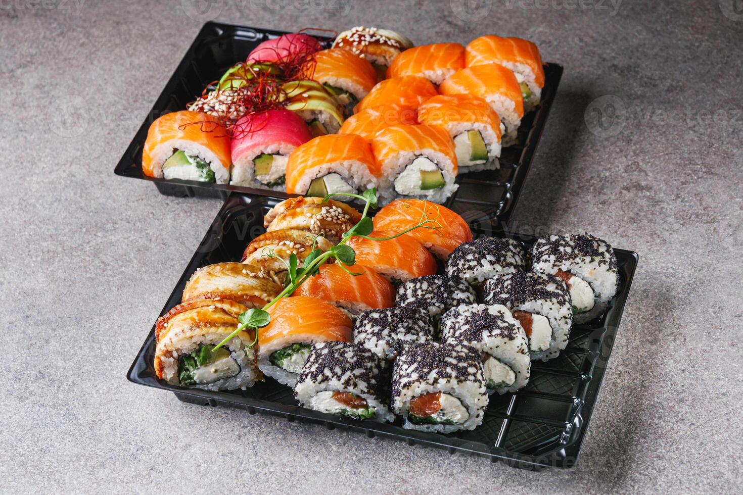 set of delicious fresh sushi roll with salmon avocado cucumber tuna eel Philadelphia cheese photo
