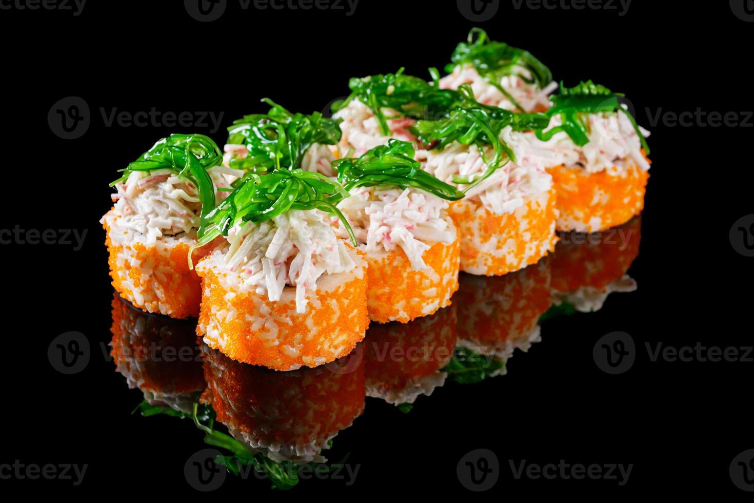 sushi roll with crab tobiko cucumber cream chukka cheese on a black mirror background photo