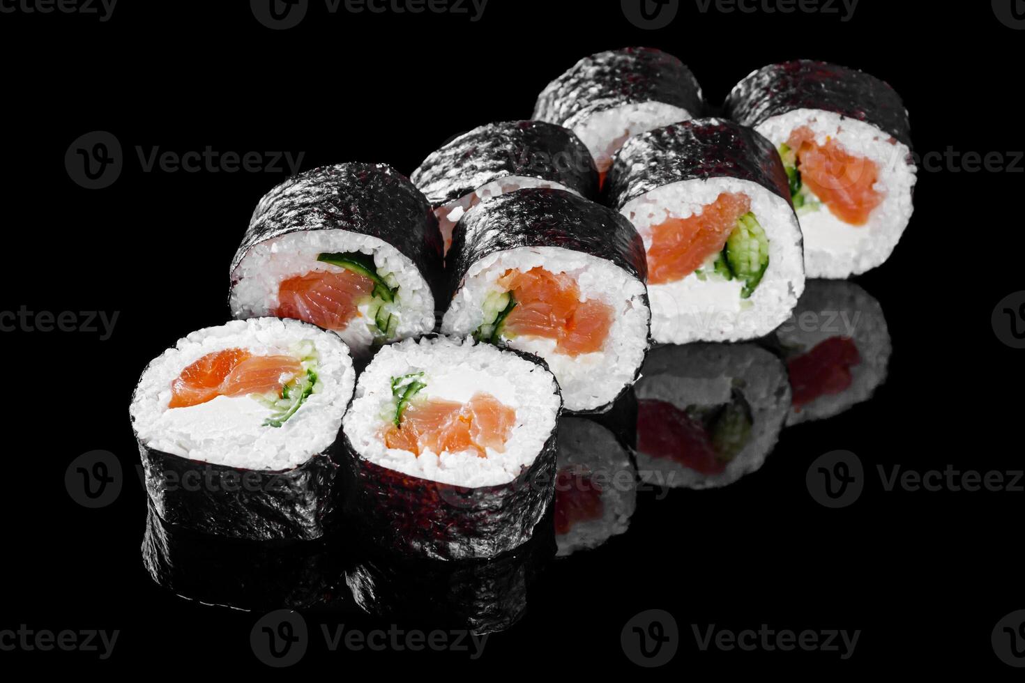 futomaki sushi roll with cucumber salmon cream cheese on a black mirror background photo