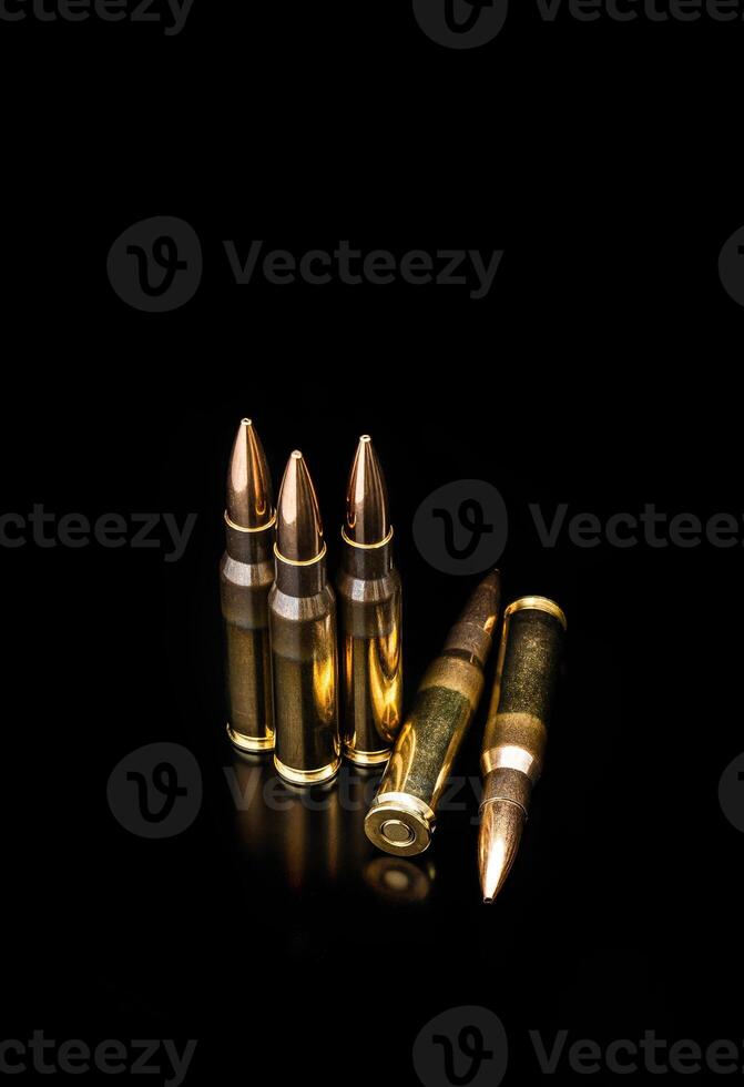 Bullet isolated on black background with reflexion. Rifle bullets close-up on black back. Cartridges for rifle and carbine on a black. photo