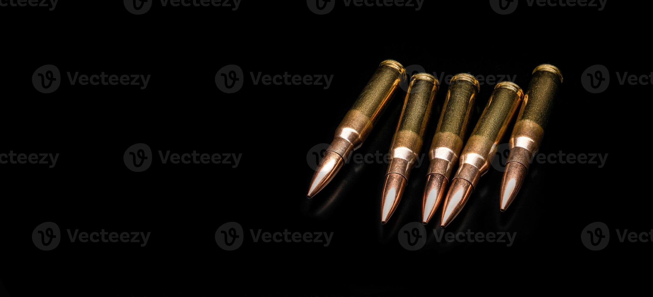 Bullet isolated on black background with reflexion. Rifle bullets close-up on black back. Cartridges for rifle and carbine on a black. photo