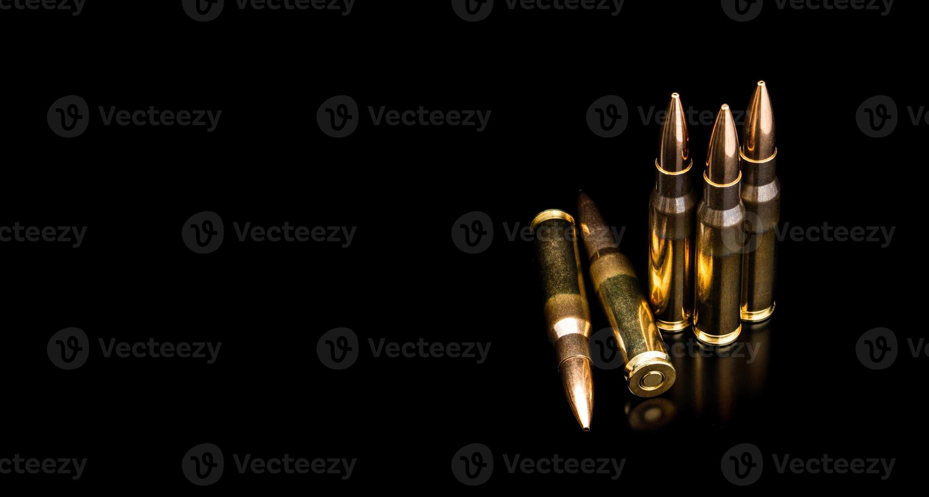 Bullet isolated on black background with reflexion. Rifle bullets close-up on black back. Cartridges for rifle and carbine on a black. photo