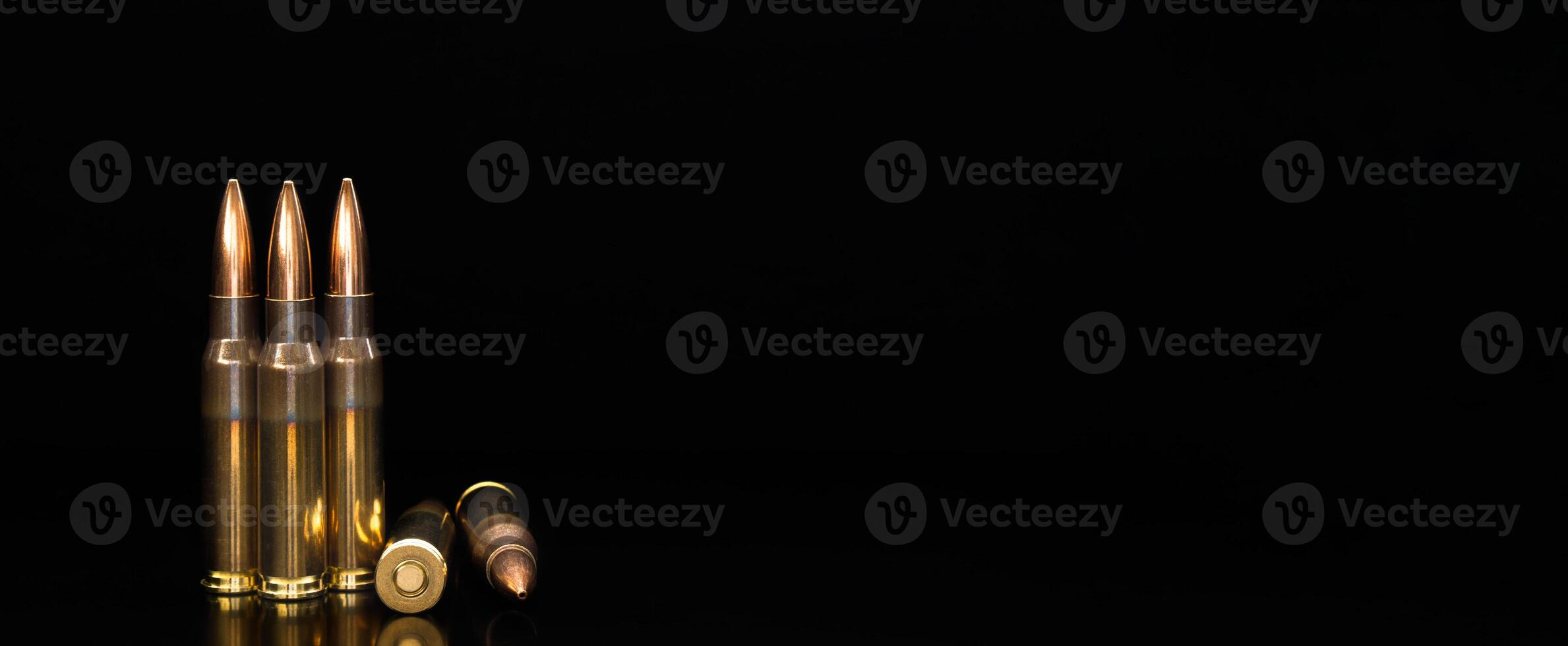 Bullet isolated on black background with reflexion. Rifle bullets close-up on black back. Cartridges for rifle and carbine on a black. photo