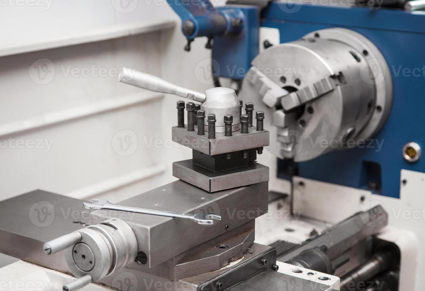 Lathe for metal processing in a workshop. A modern lathe for processing metal and other materials. photo