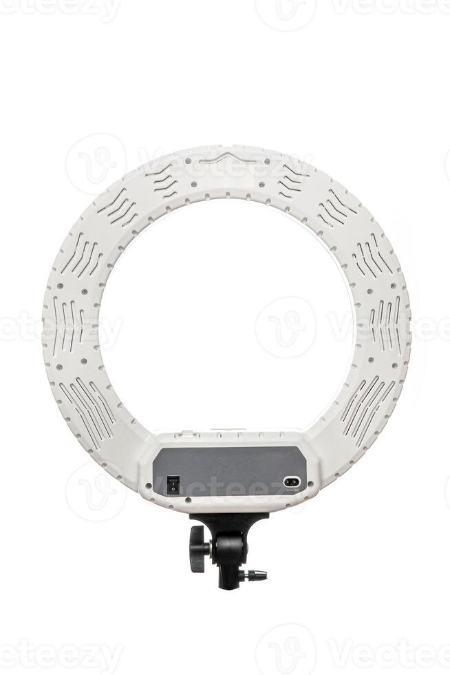 Closeup of circular neon LED lamp isolated white background. Popular modern light for make-up and beauty portraits. photo