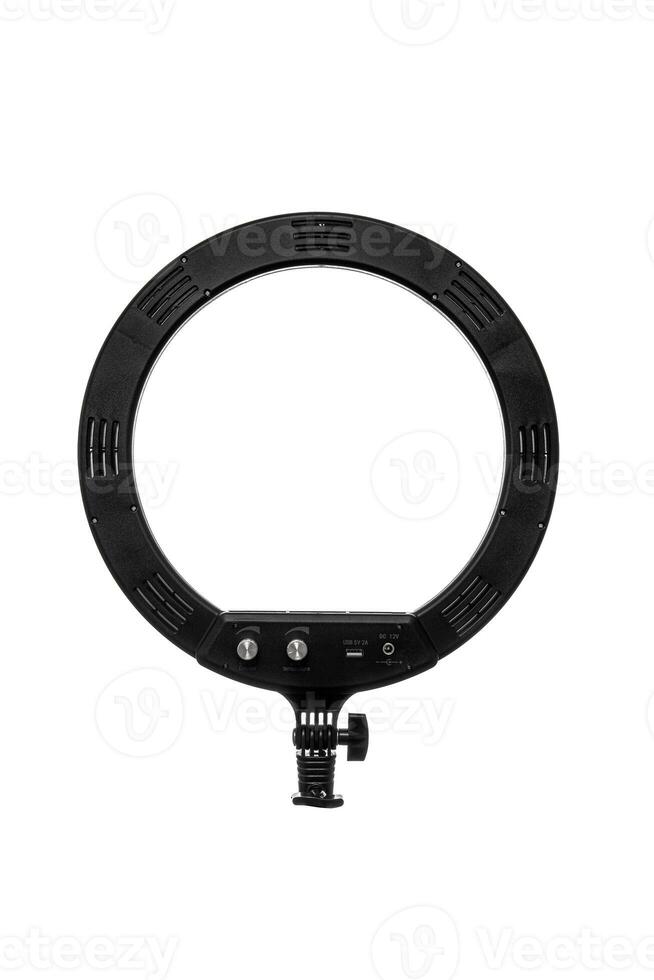 Closeup of circular neon LED lamp isolated white background. Popular modern light for make-up and beauty portraits. photo
