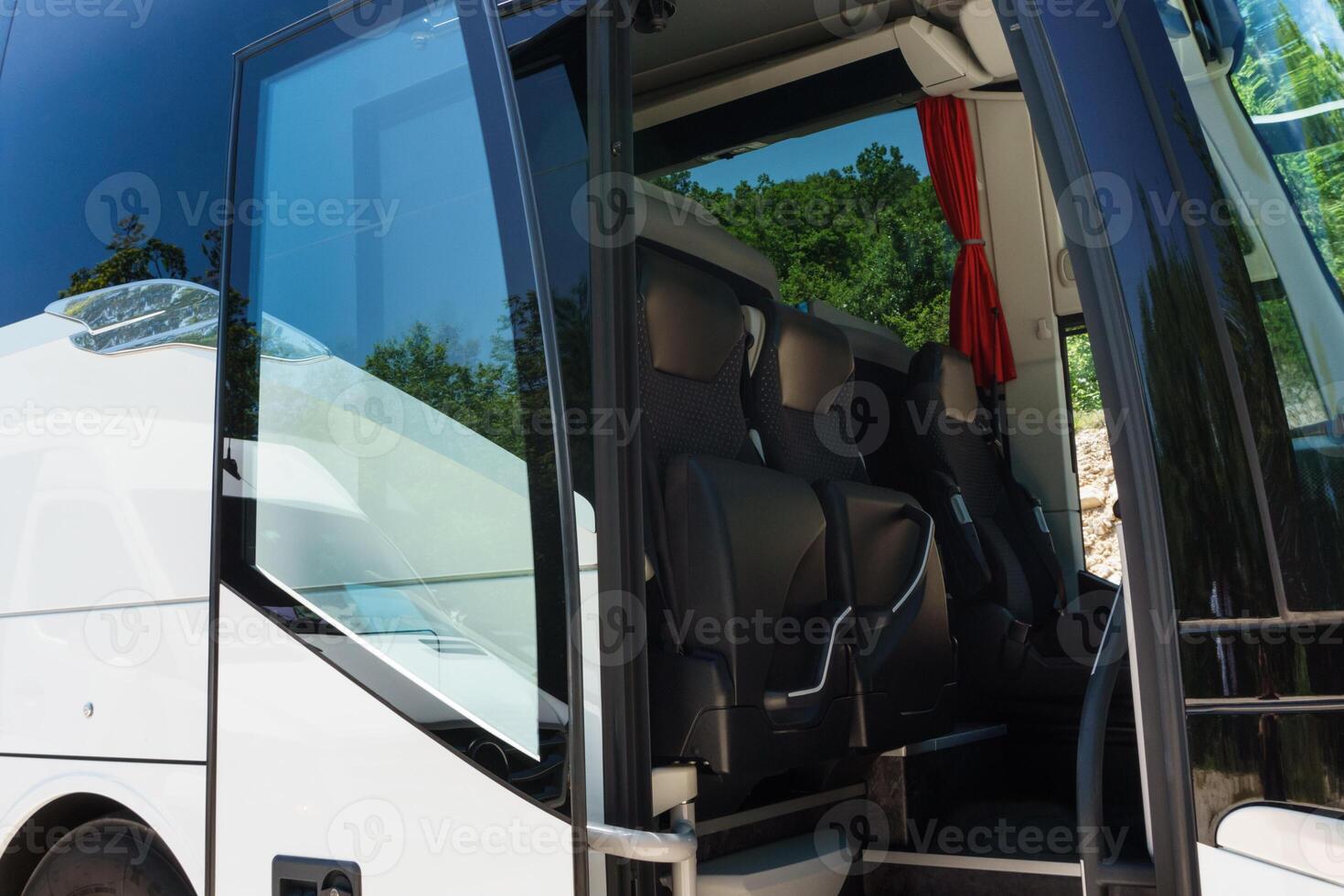 Modern buses for transporting people stand at the bus stop. Close-up of an open bus door. Light back. photo