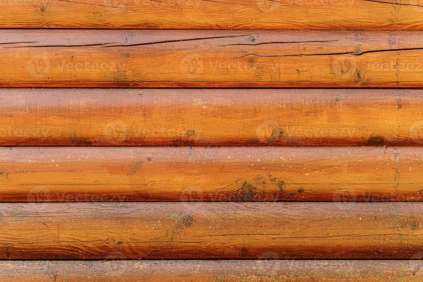 Log back. Rough wood texture. The walls of a country house are made of rough logs or boards. photo