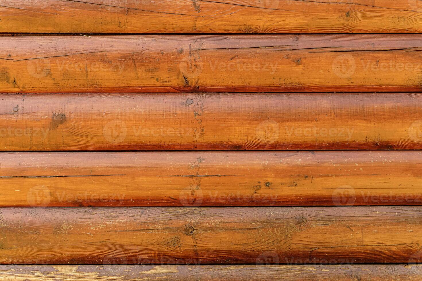 Log back. Rough wood texture. The walls of a country house are made of rough logs or boards. photo