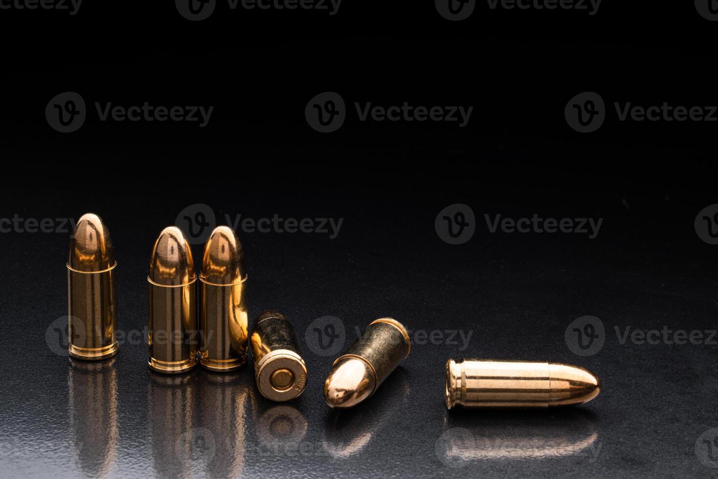 Bullet isolated on black background with reflexion. Rifle bullets close-up on black back. Cartridges for rifle and carbine on a black. photo