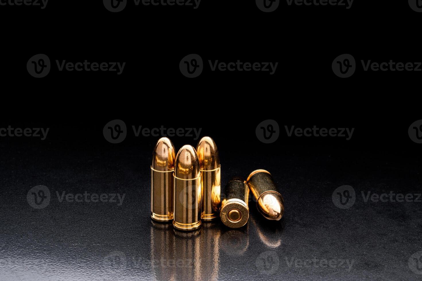 Bullet isolated on black background with reflexion. Rifle bullets close-up on black back. Cartridges for rifle and carbine on a black. photo