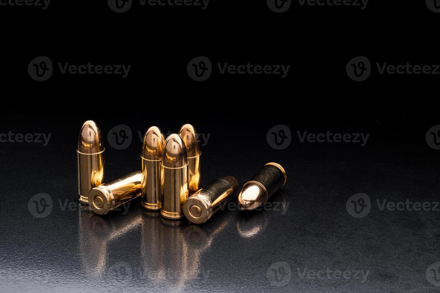Bullet isolated on black background with reflexion. Rifle bullets close-up on black back. Cartridges for rifle and carbine on a black. photo