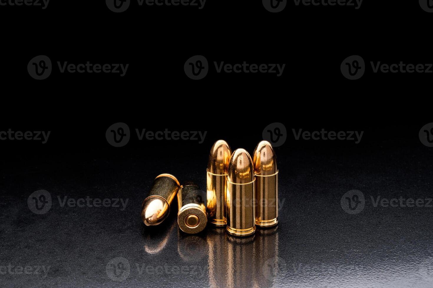 Bullet isolated on black background with reflexion. Rifle bullets close-up on black back. Cartridges for rifle and carbine on a black. photo
