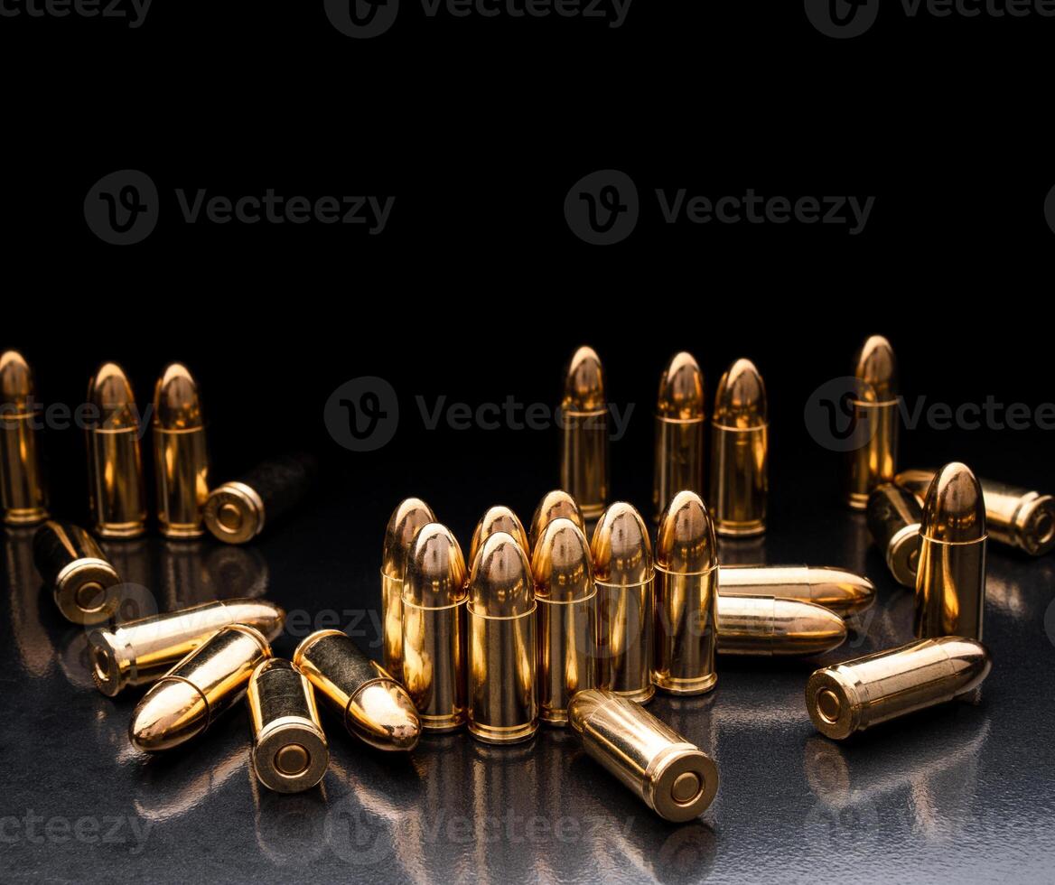 Bullet isolated on black background with reflexion. Rifle bullets close-up on black back. Cartridges for rifle and carbine on a black. photo