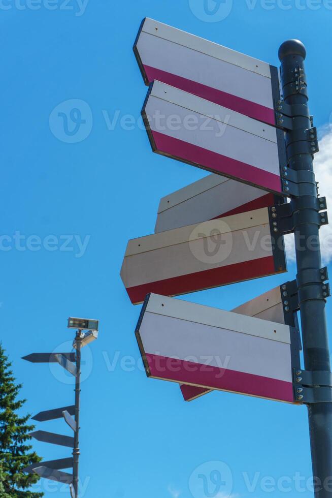 Blank directional road signs against blue sky. Directional sign post. Blue back. photo