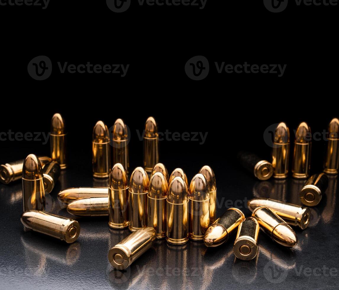 Bullet isolated on black background with reflexion. Rifle bullets close-up on black back. Cartridges for rifle and carbine on a black. photo