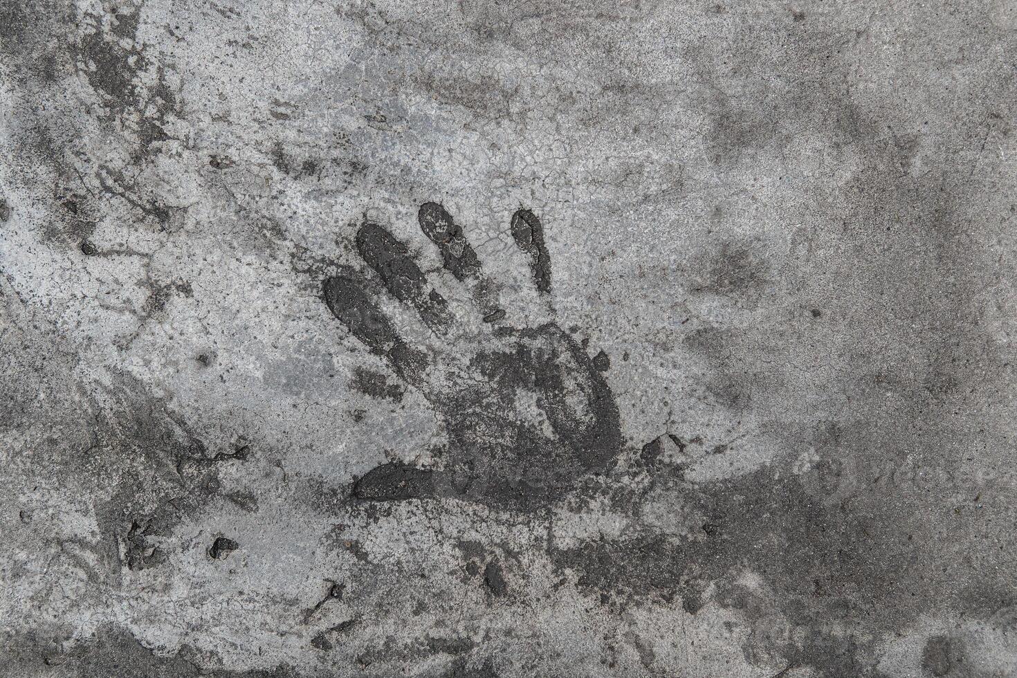 Handprint on cement. Memorable handprint of a hand in an old concrete wall. Copy space for text. photo