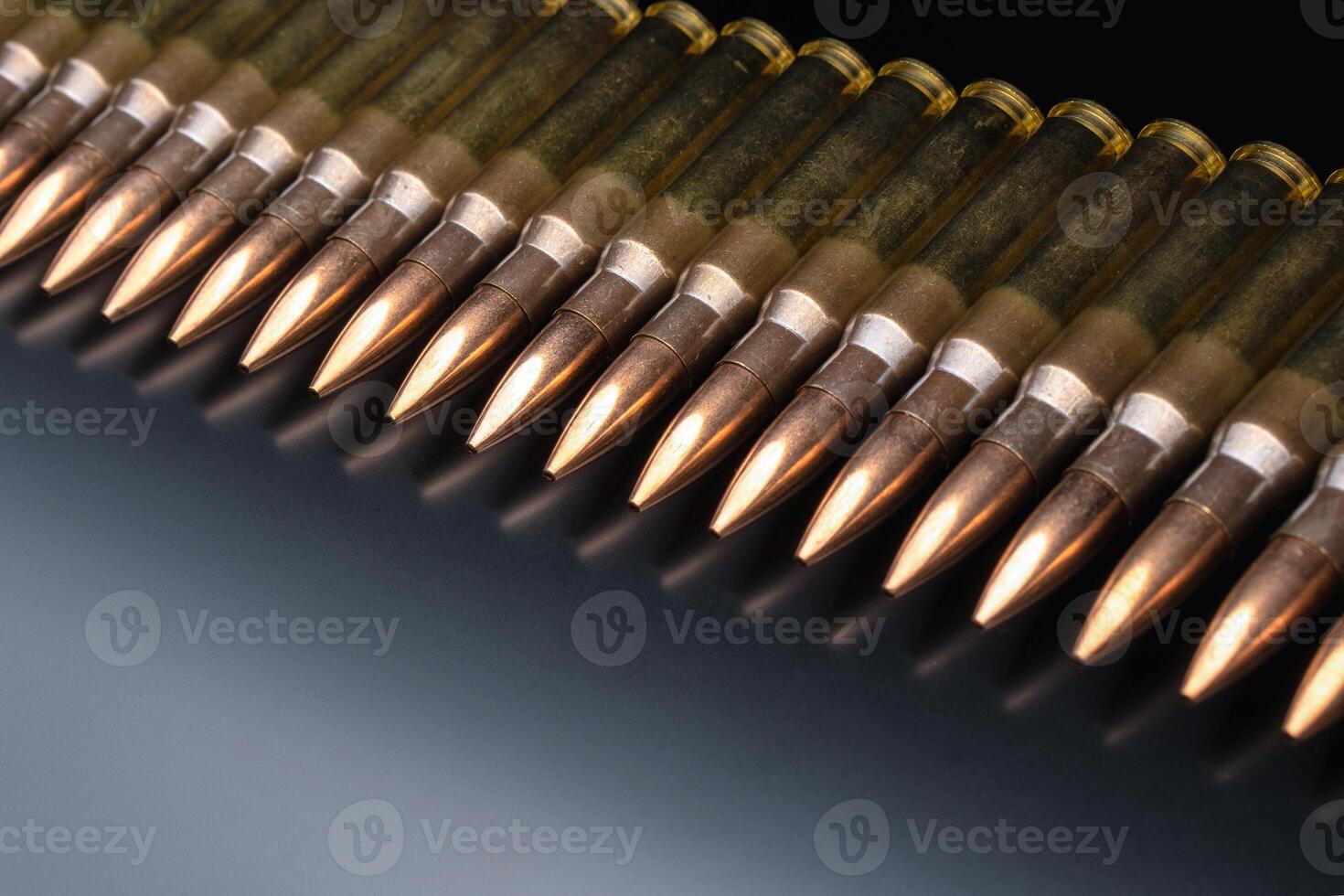 Bullet isolated on black background with reflexion. Rifle bullets close-up on black back. Cartridges for rifle and carbine on a black. photo