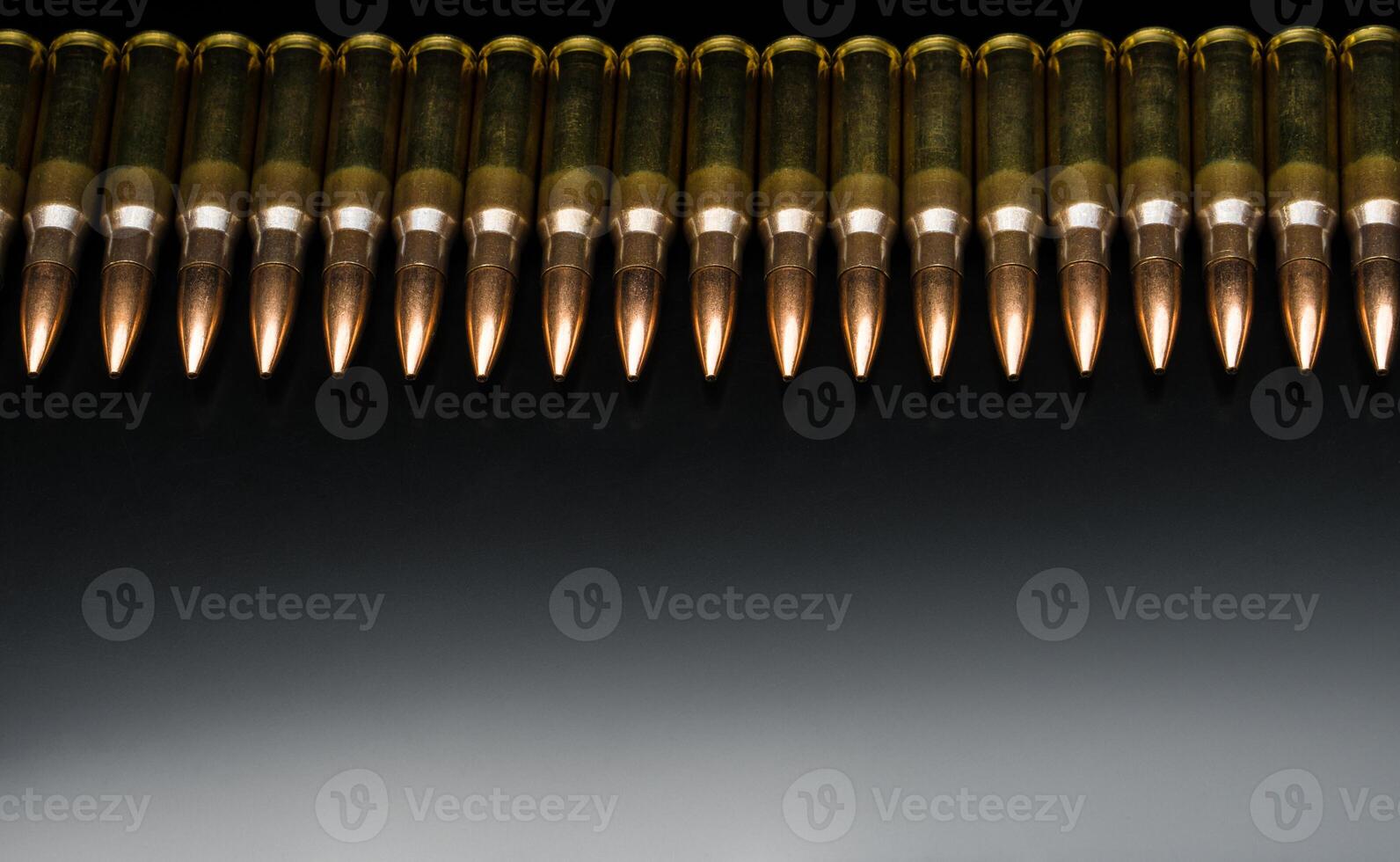 Rifle bullets close-up on black back. Cartridges for rifle and carbine on a black. Bullet isolated on black background with reflexion. photo