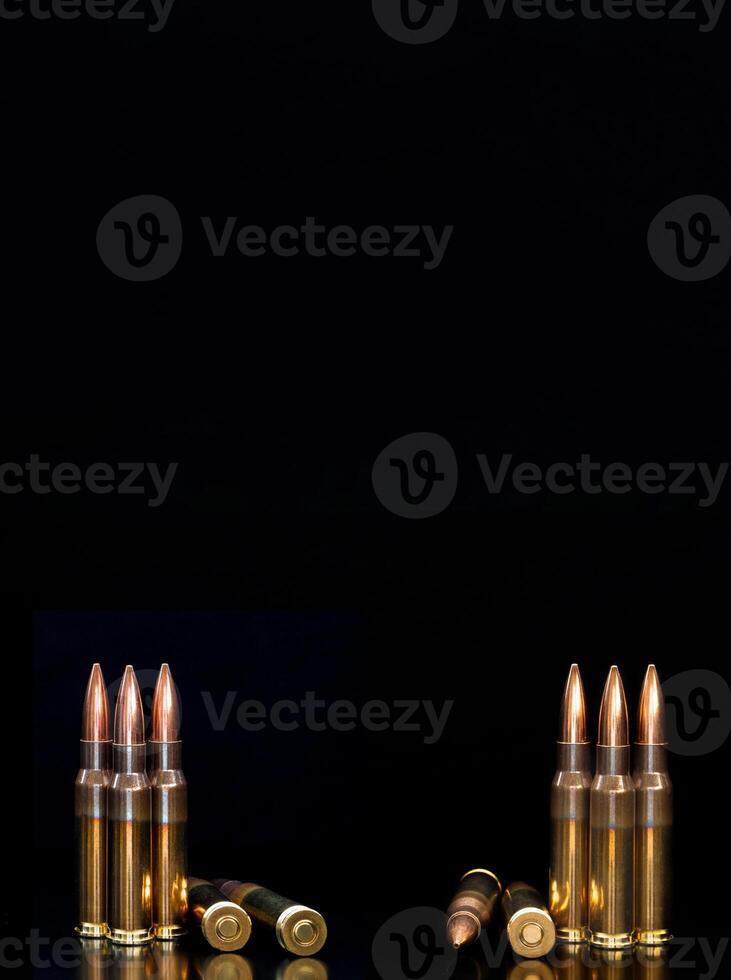 Bullet isolated on black background with reflexion. Rifle bullets close-up on black back. Cartridges for rifle and carbine on a black. photo