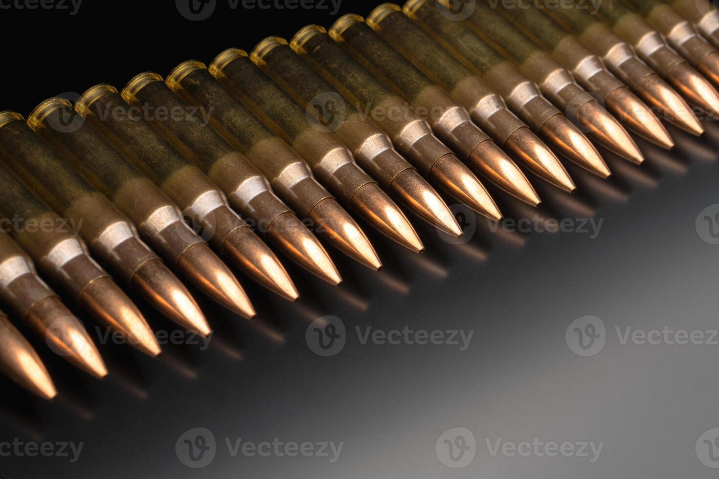 Bullet isolated on black background with reflexion. Rifle bullets close-up on black back. Cartridges for rifle and carbine on a black. photo