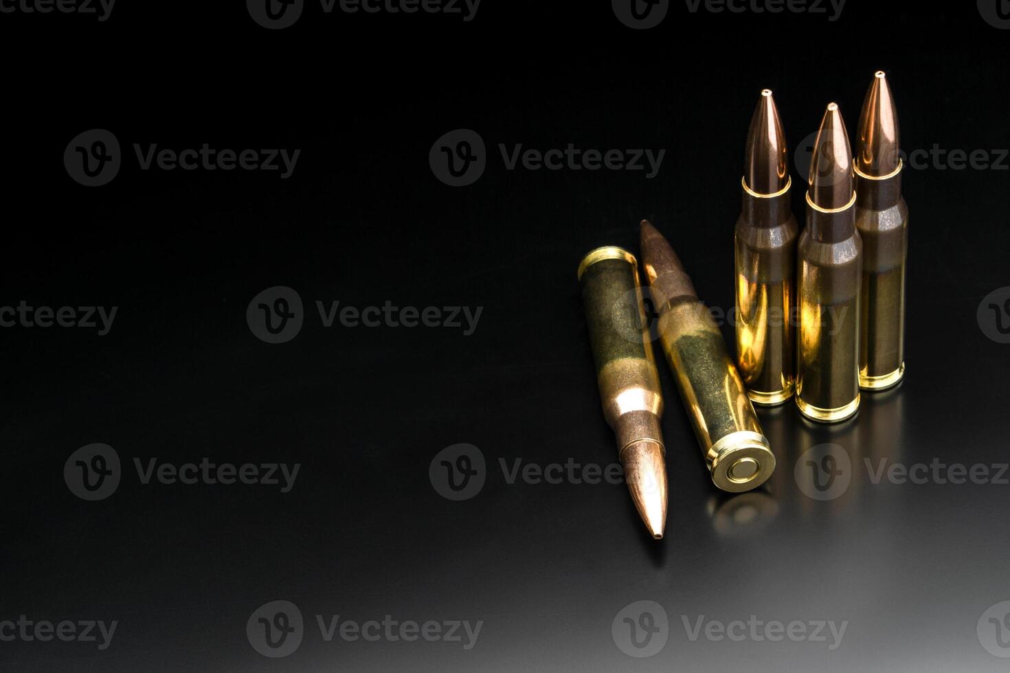 Bullet isolated on black background with reflexion. Rifle bullets close-up on black back. Cartridges for rifle and carbine on a black. photo