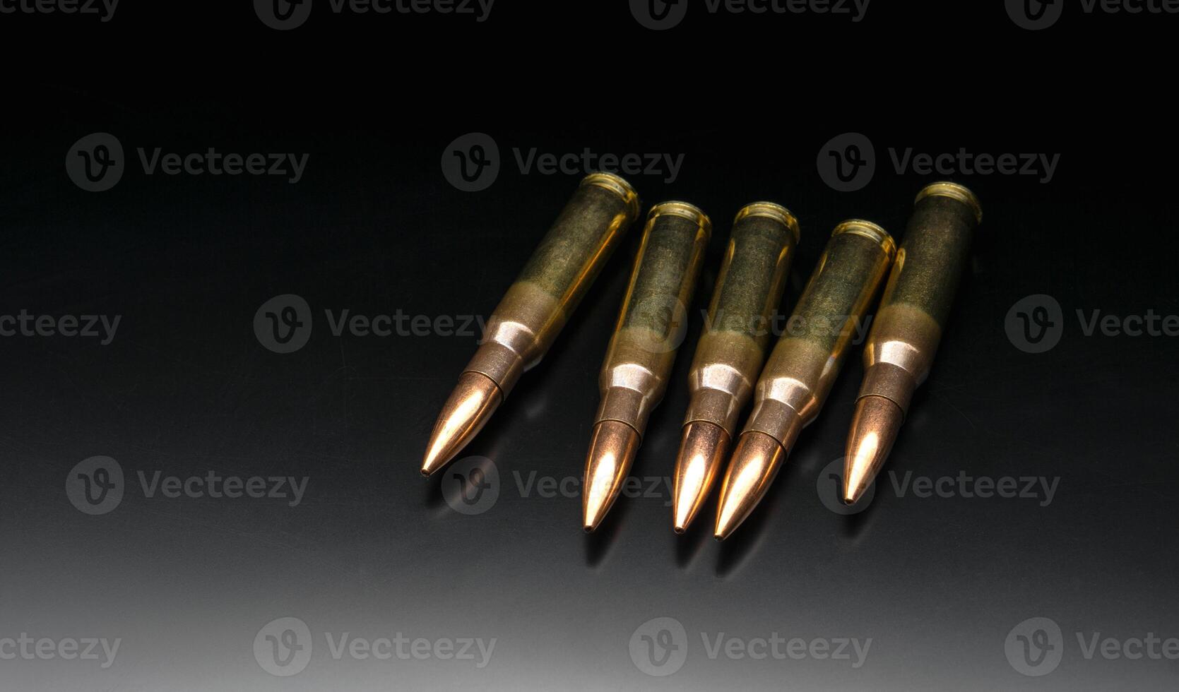 Bullet isolated on black background with reflexion. Rifle bullets close-up on black back. Cartridges for rifle and carbine on a black. photo