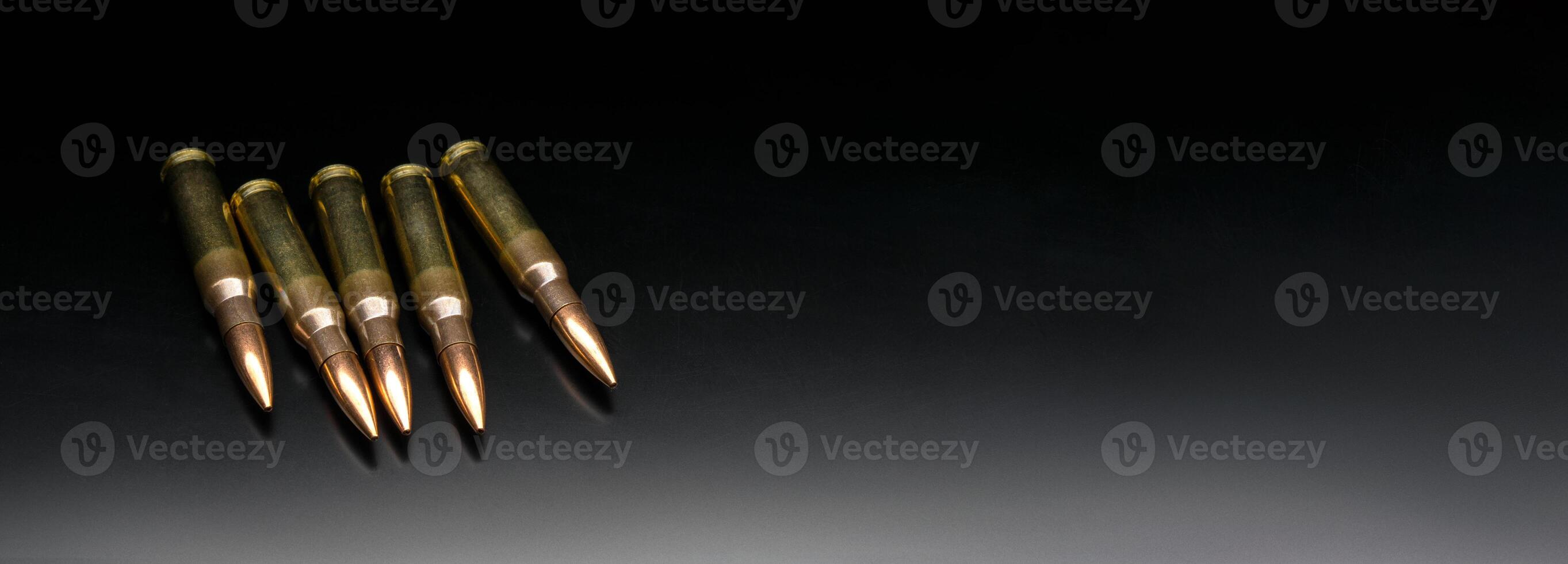 Bullet isolated on black background with reflexion. Rifle bullets close-up on black back. Cartridges for rifle and carbine on a black. photo