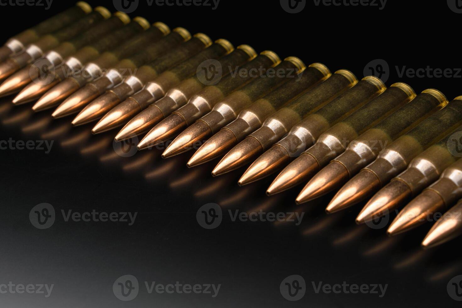 Bullet isolated on black background with reflexion. Rifle bullets close-up on black back. Cartridges for rifle and carbine on a black. photo