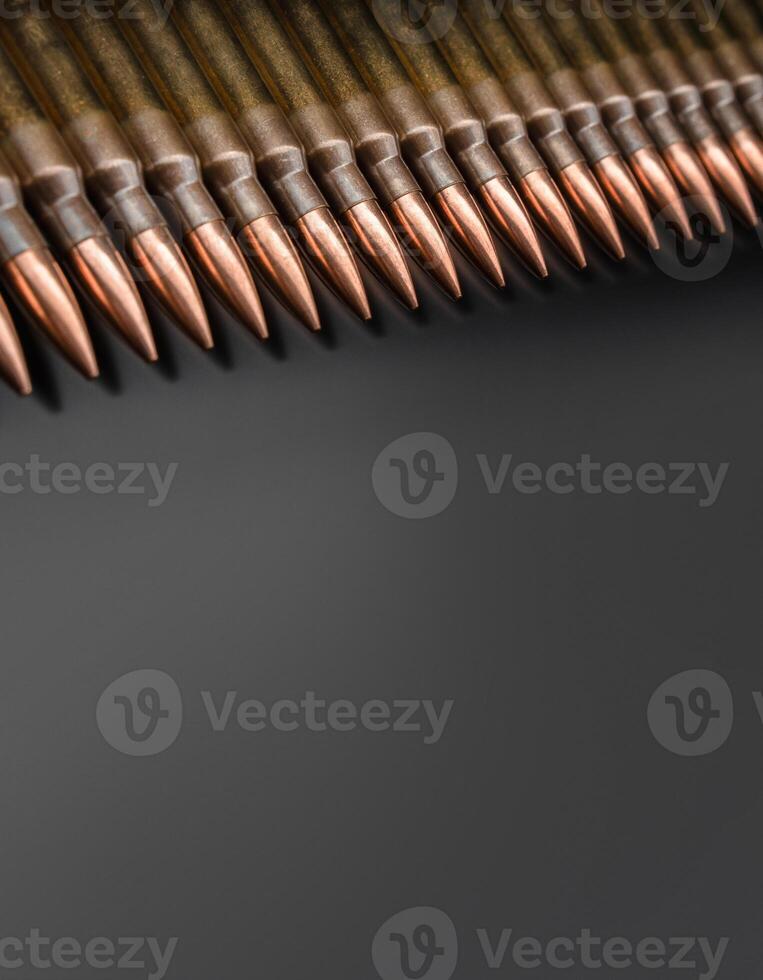 Rifle bullets close-up on black back. Cartridges for rifle and carbine on a black. Bullet isolated on black background with reflexion. photo