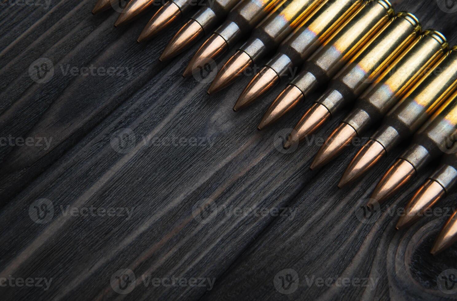 artridges for weapons on a wooden back. Ammunition on a vintage table. Cartridges for rifles and carbines photo