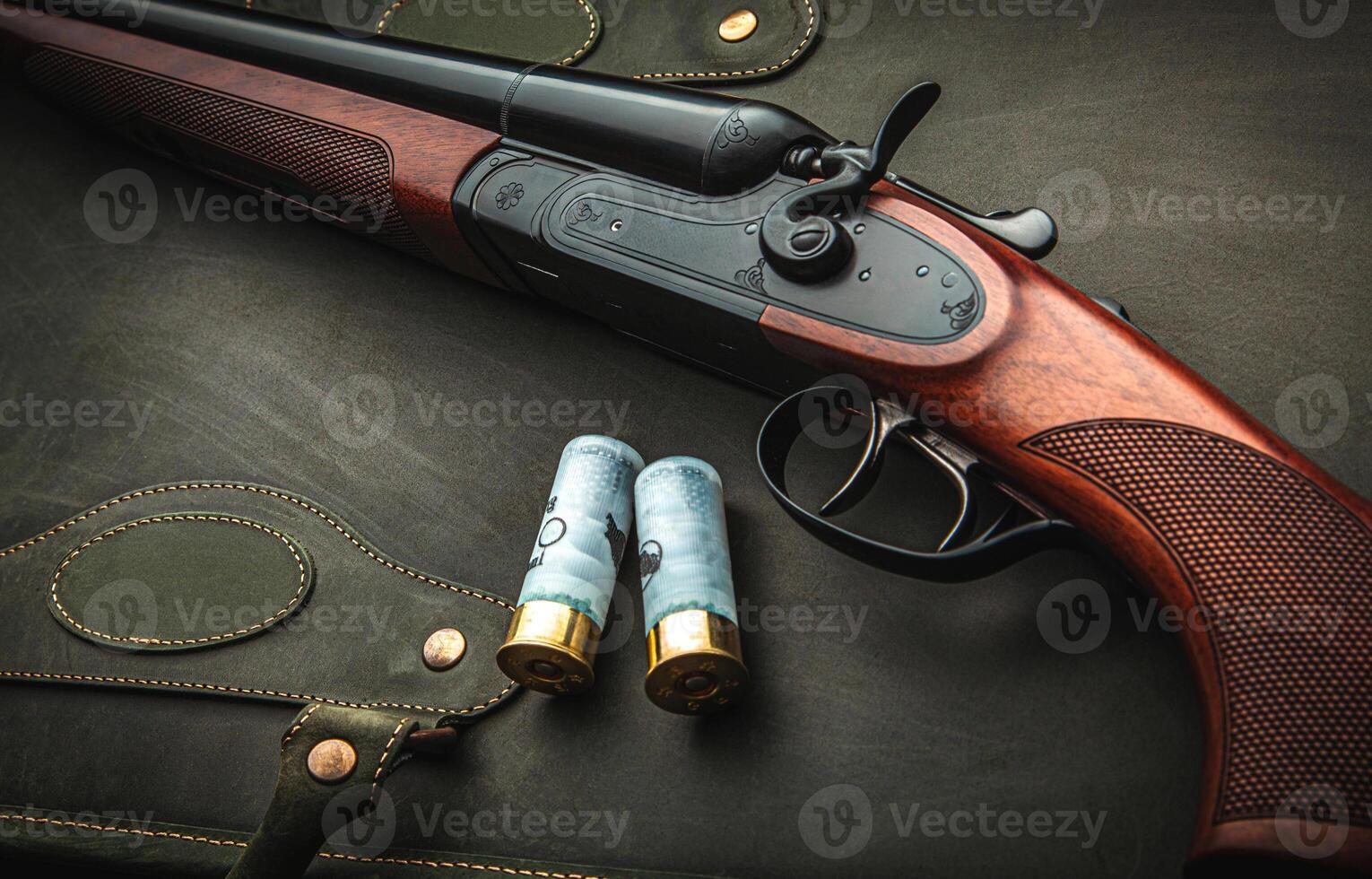 Classic trigger double-barreled hunting rifle on a green background. Smooth-bore hunting rifle open for reloading. Concept postcards for hunters. photo