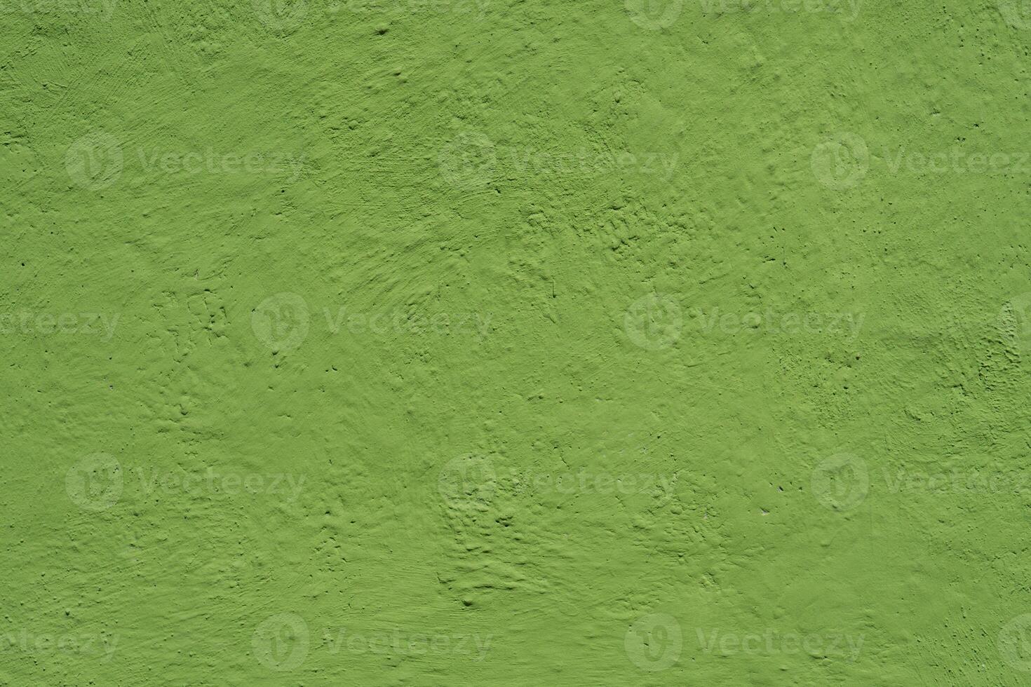 Wall painted in green. Bright green grungy background. photo