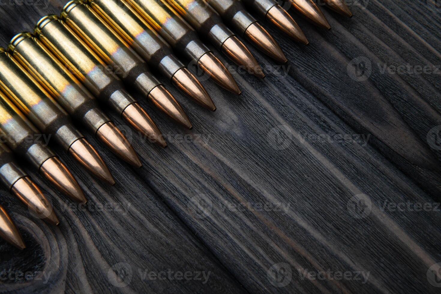 artridges for weapons on a wooden back. Ammunition on a vintage table. Cartridges for rifles and carbines photo