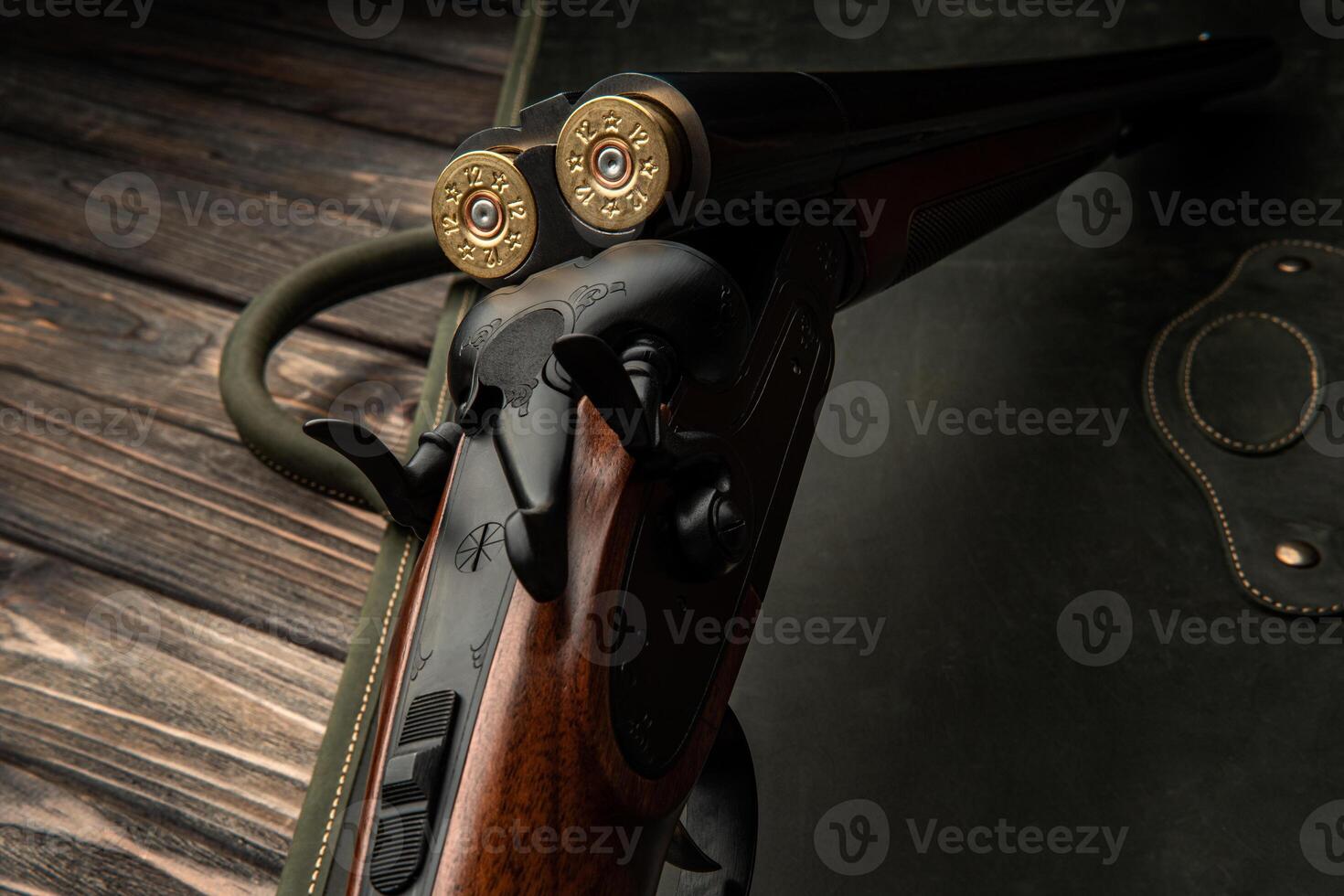 Classic trigger double-barreled hunting rifle on a green back. Smooth-bore hunting rifle open for reloading. Concept postcards for hunters. photo