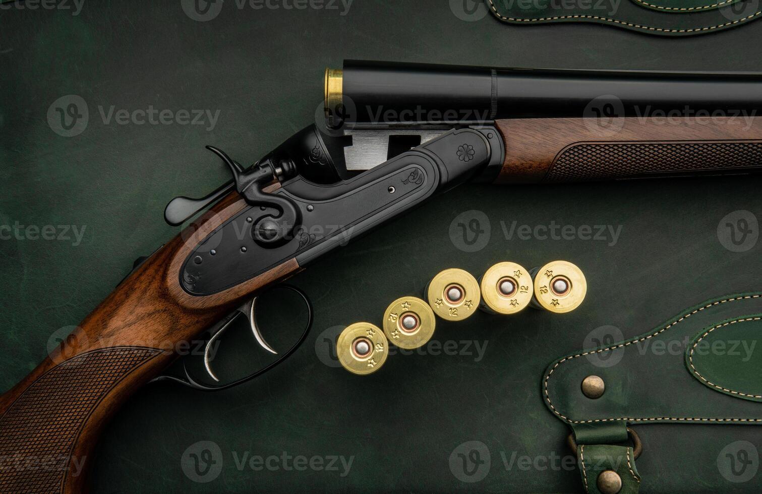 Classic trigger double-barreled hunting rifle on a green background. Smooth-bore hunting rifle open for reloading. Concept postcards for hunters. photo