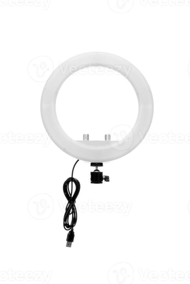 Closeup of circular neon LED lamp isolated white background. Popular modern light for make-up and beauty portraits. photo