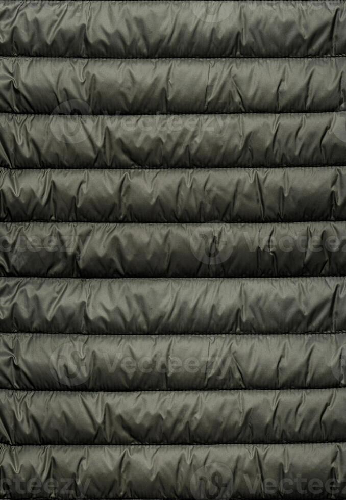 Quilted pattern. Texture of puffer, padded, down jacket. Background of urban winter outfit. photo