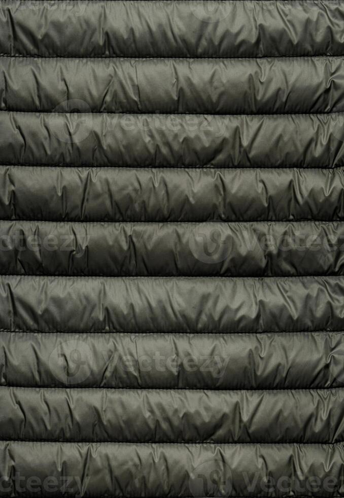Quilted pattern. Texture of puffer, padded, down jacket. Background of urban winter outfit. photo