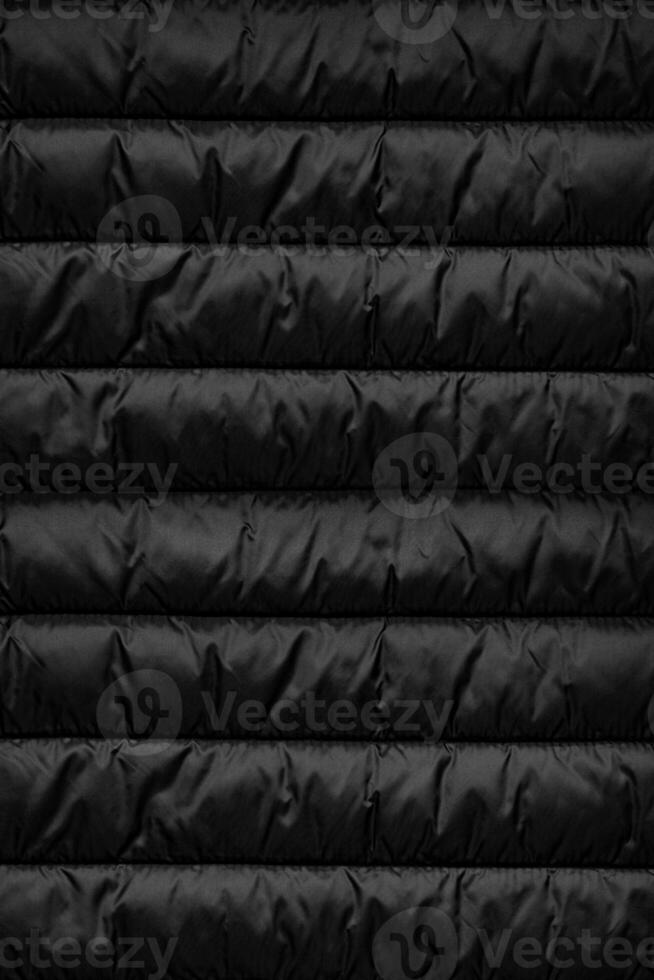 Quilted pattern. Texture of puffer, padded, down jacket. Background of urban winter outfit. photo