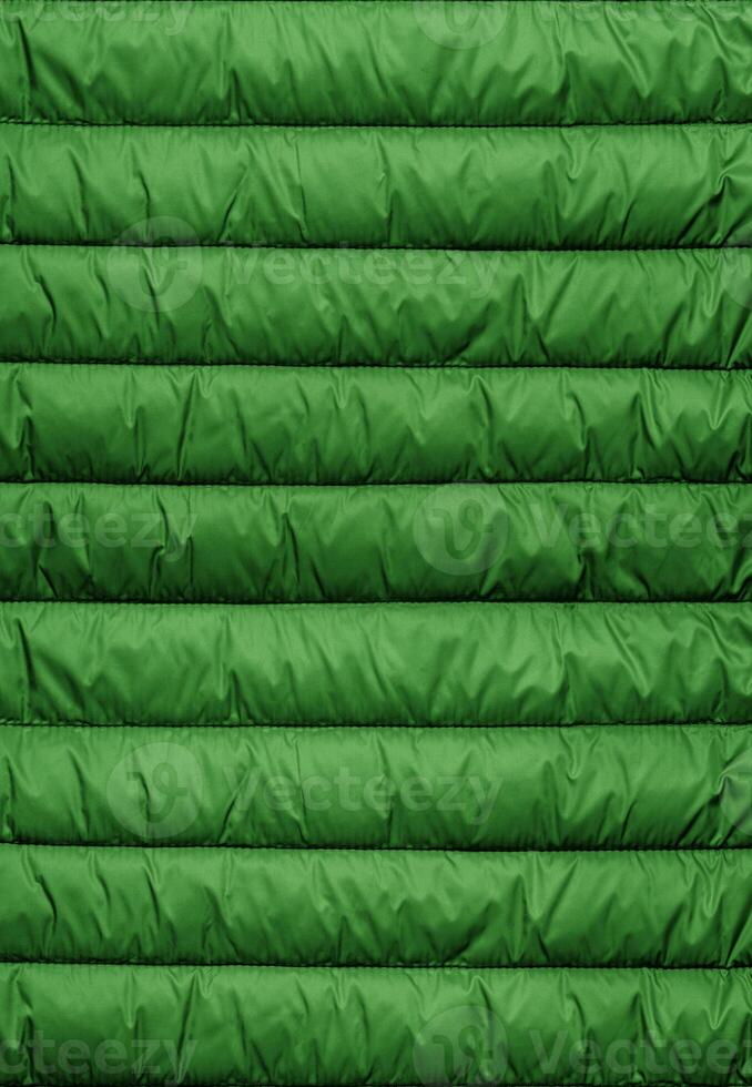 Quilted pattern. Texture of puffer, padded, down jacket. Background of urban winter outfit. photo