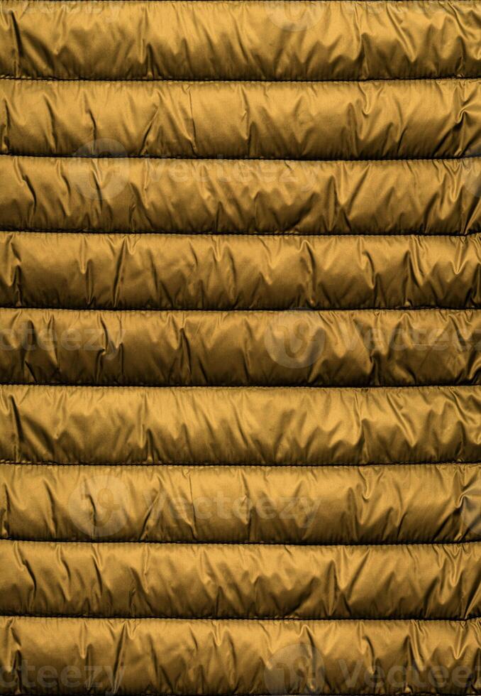 Quilted pattern. Texture of puffer, padded, down jacket. Background of urban winter outfit. photo