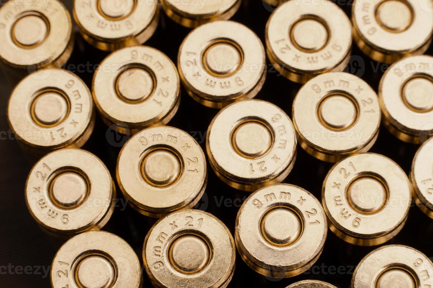 Close-up of a group of 9mm rounds. Cartridge back. New cartridges stacked neatly near each other. photo