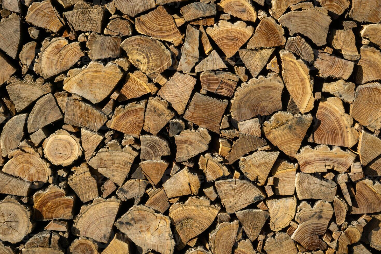 Neatly stacked firewood. Background of dry chopped logs photo