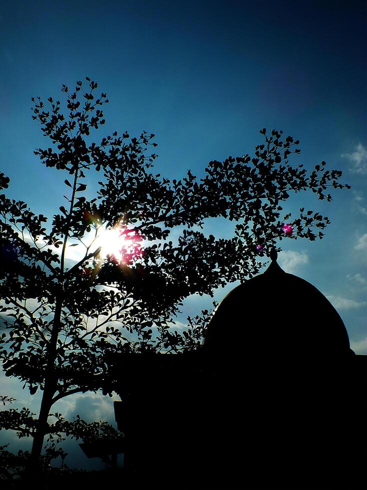 view of a silhouette of the elegance mosque dome with clear blue sky for eid mubarak, ramadan. Celebrating tranquil Islamic style photo