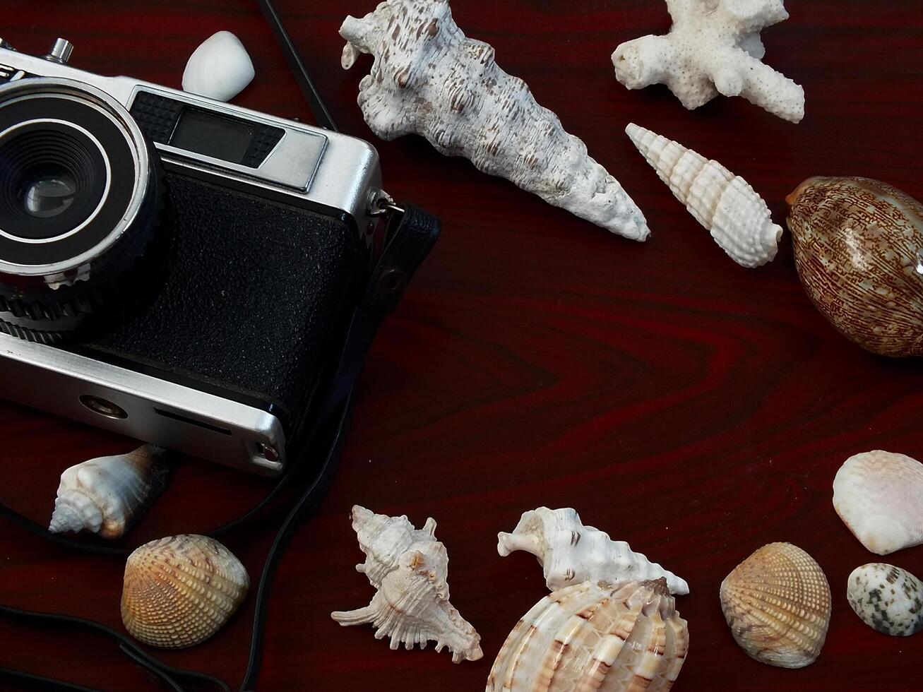 old vintage camera gear on wooden table background. top view, flat lay. Retro vintage concept. Travel and journey design element photo